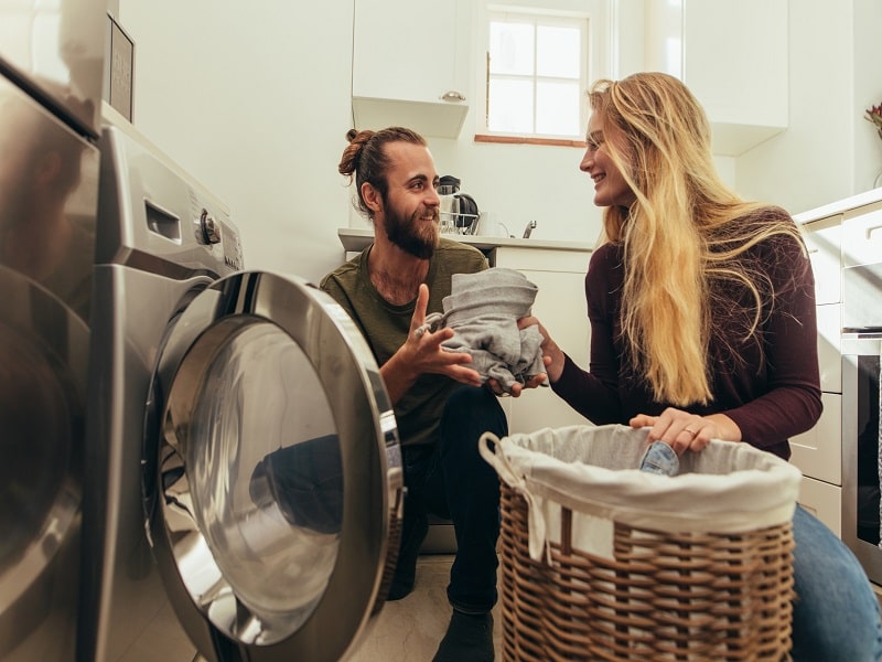 Couple doing laundry plate full of delight